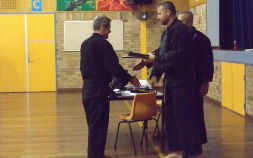 Martial artist being awarded black belt